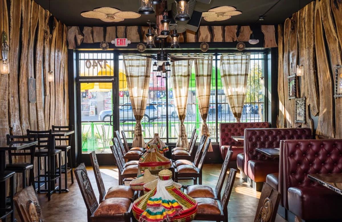 The Phoenix dining room with carved wood walls and red booths